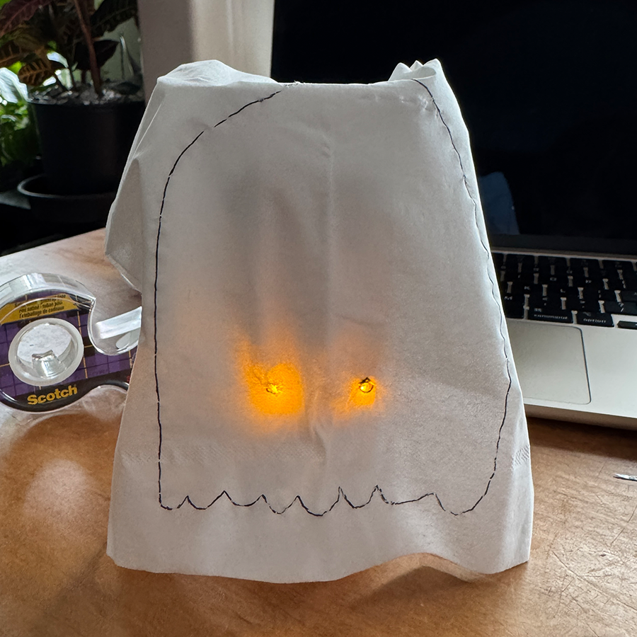 This is the ghost in his full form. I draped a tissue over him and taped it so that it fit well. I also cut little holes so his eyes would glow better and I drew an outline of a ghost on the tissue.